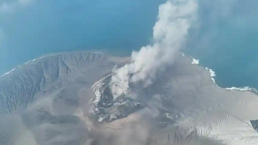 Anak Krakatau volcano erupting in Indonesia with a large ash plume rising above the Sunda Strait