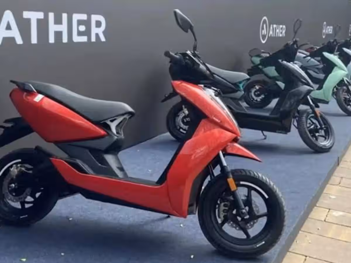 A sleek Ather electric scooter being charged in a modern urban setting, representing the brand's international expansion into global EV markets.