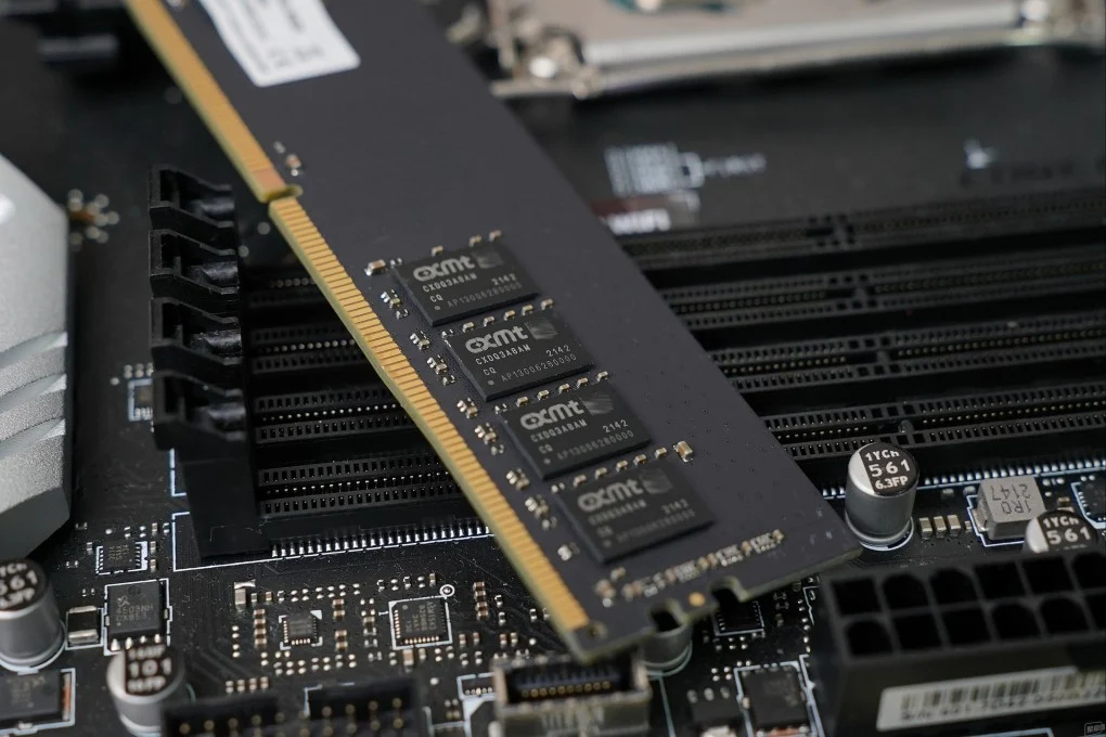 A macro photograph of a modern silicon wafer and advanced DRAM integrated circuit memory modules.