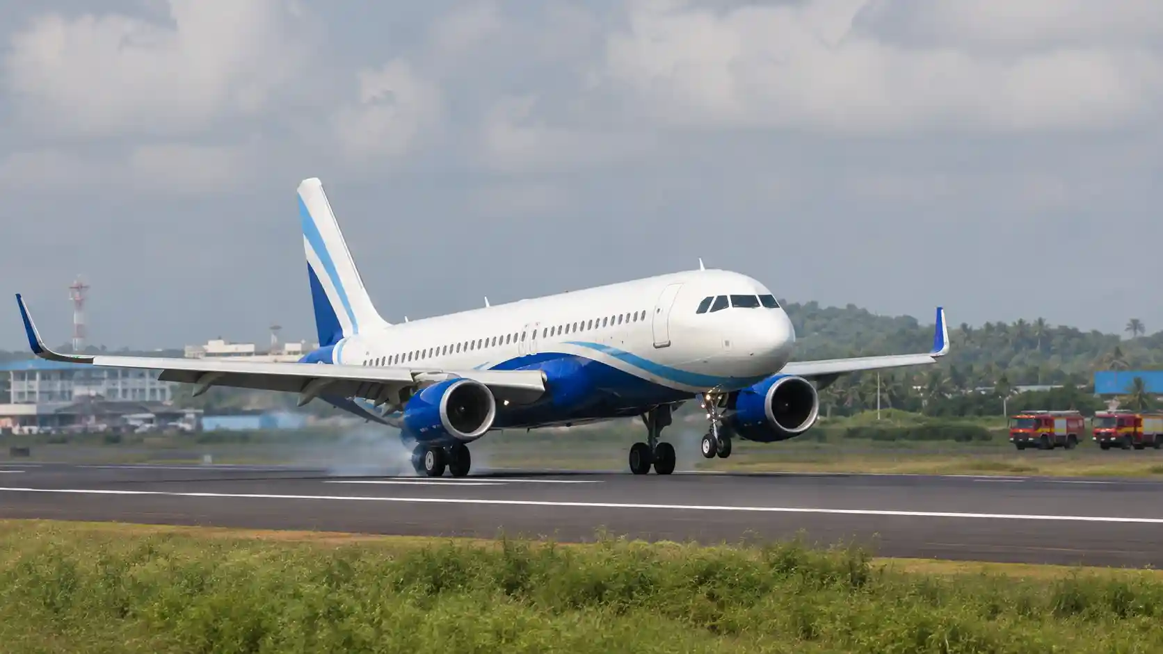 An IndiGo Airbus passenger aircraft parked on an airport tarmac.