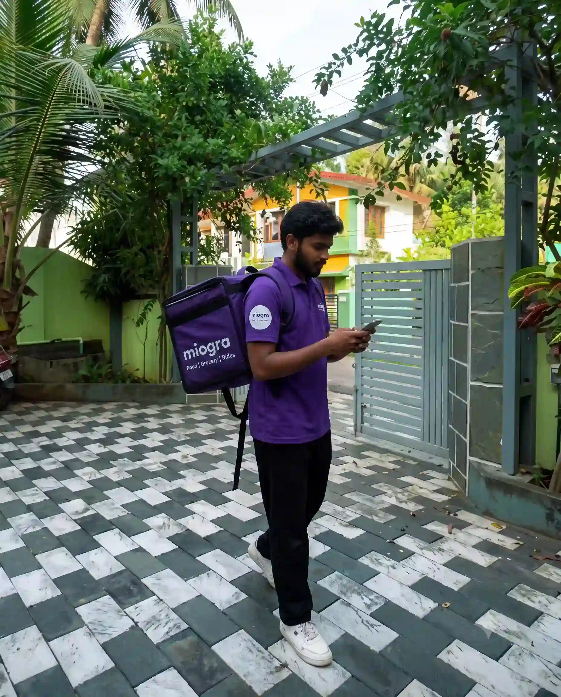 A local delivery executive picking up groceries from a neighbourhood shop in Tamil Nadu.