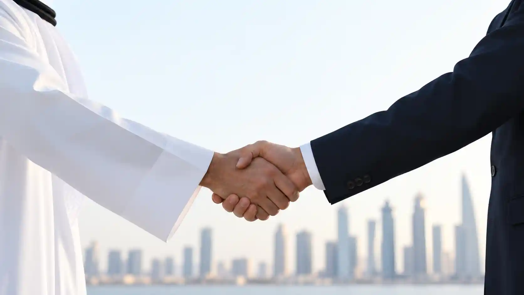 A professional business handshake in front of digital financial market charts, representing the QIA and JPMorgan global investment partnership.