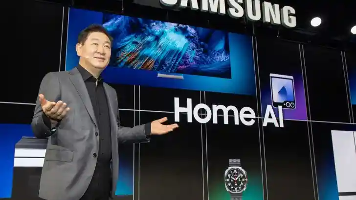 A modern presentation stage with a screen displaying 'Your Companion in Life with AI', surrounded by seated attendees.