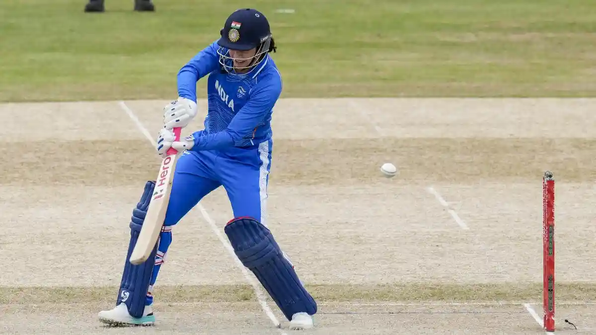 Smriti Mandhana playing a stylish off-side drive during a Women's T20 International match.