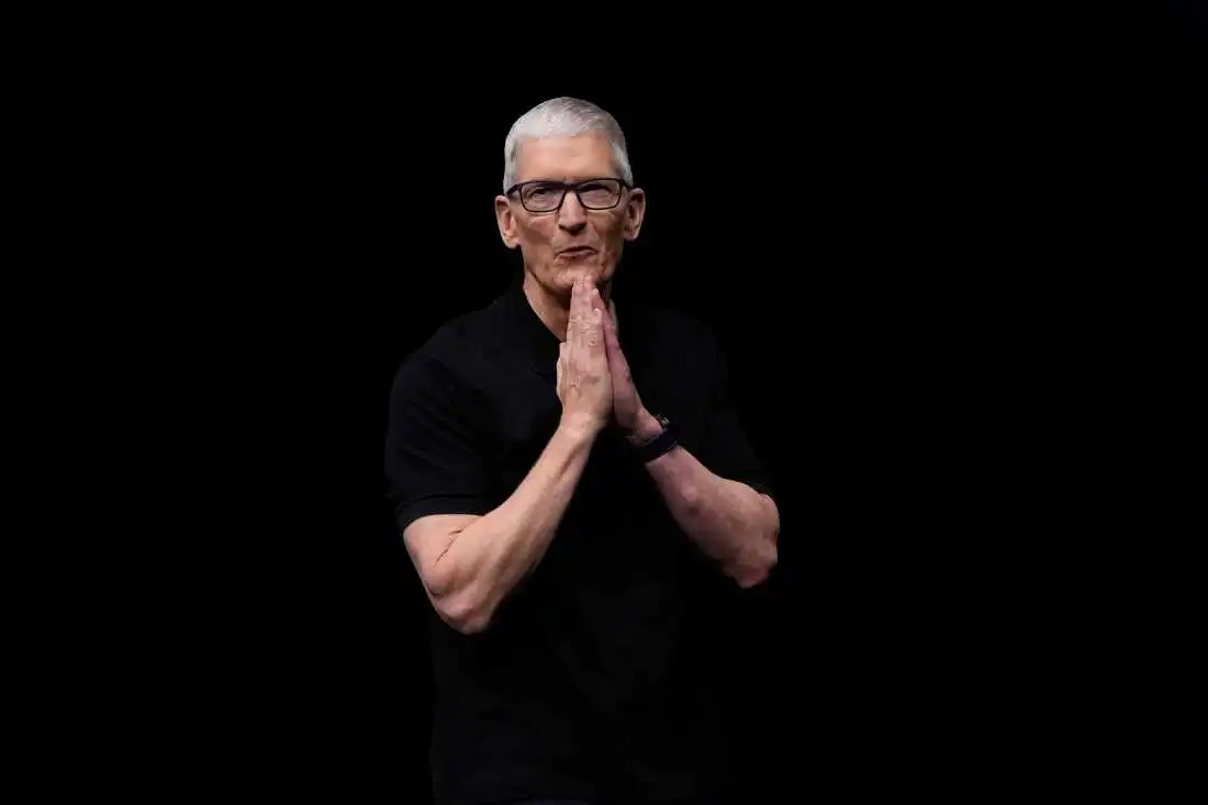 John Ternus and Tim Cook standing together at an Apple keynote event.